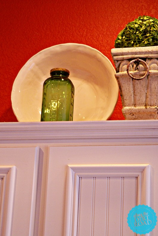 This little green juice and water jar was given to me by a friend at Christmas.  I love it.  The white piece of ceramic behind...was free at an antique mall booth.  It has a crack in it...but well loved things are welcome in our home.